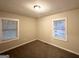 Comfortable bedroom featuring two windows and neutral carpet at 648 Ozburn Nw Rd, Atlanta, GA 30318