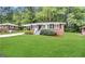 Charming single-story home featuring a well-maintained lawn and brick exterior at 648 Ozburn Nw Rd, Atlanta, GA 30318