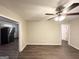 Open living room featuring hardwood floors and ceiling fan, adjacent to kitchen at 648 Ozburn Nw Rd, Atlanta, GA 30318