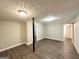 Unfinished basement featuring wood-look floors and a black support column at 3174 Kingston Nw Rd, Atlanta, GA 30318