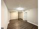 Unfinished basement featuring wood-look floors and a black support column at 3174 Kingston Nw Rd, Atlanta, GA 30318
