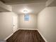 Finished basement room with wood-look flooring and natural light at 3174 Kingston Nw Rd, Atlanta, GA 30318