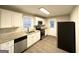 Modern kitchen with white cabinets, stainless steel appliances, and granite countertops at 3174 Kingston Nw Rd, Atlanta, GA 30318