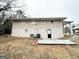 Backyard view of the home featuring a patio and landscaped yard with mature trees at 4250 Utoy Sw Ct, Atlanta, GA 30331