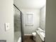 Modern bathroom with a shower, granite countertop, and a neutral color palette at 4250 Utoy Sw Ct, Atlanta, GA 30331