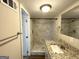 Bathroom featuring a glass enclosed tile shower, granite countertop and stainless steel fixtures at 4250 Utoy Sw Ct, Atlanta, GA 30331