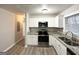 Well-equipped kitchen featuring stainless steel appliances, granite counters, and white cabinetry at 4250 Utoy Sw Ct, Atlanta, GA 30331