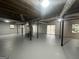 Large unfinished basement with gray painted concrete floor, sliding glass doors, and exposed ceiling at 6982 Knollwood Dr, Morrow, GA 30260