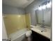 A bathroom featuring a tub, toilet, and vanity with dark cabinets at 6982 Knollwood Dr, Morrow, GA 30260
