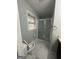 This bathroom features gray tile floors, shower, and updated fixtures at 6982 Knollwood Dr, Morrow, GA 30260