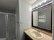 This bathroom features neutral countertops, shower, and decorative lighting at 6982 Knollwood Dr, Morrow, GA 30260