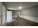 This bedroom features modern wood-look flooring, neutral paint, and recessed lighting at 6982 Knollwood Dr, Morrow, GA 30260