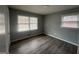 Bedroom with modern wood-look flooring, neutral paint, and bright natural light at 6982 Knollwood Dr, Morrow, GA 30260