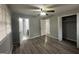 This bedroom features wood-look flooring and access to the bathroom and closet at 6982 Knollwood Dr, Morrow, GA 30260
