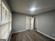 Bedroom with modern wood-look flooring, neutral paint, and bright natural light at 6982 Knollwood Dr, Morrow, GA 30260