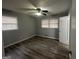 This bedroom features modern ceiling fan, gray walls, and wood-look flooring at 6982 Knollwood Dr, Morrow, GA 30260