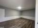 This bedroom features modern wood-look flooring, neutral paint, and recessed lighting at 6982 Knollwood Dr, Morrow, GA 30260