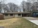 Charming single-story home featuring a covered carport and mature trees in a quiet neighborhood at 6982 Knollwood Dr, Morrow, GA 30260