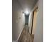 A well-lit hallway features laminate flooring and neutral paint at 6982 Knollwood Dr, Morrow, GA 30260