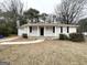 Ranch-style home featuring a well-maintained lawn and classic brick exterior at 1756 Lynn Ln, Decatur, GA 30032