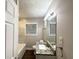 Updated bathroom with modern vanity, granite countertop, and tiled shower with tub at 1761 Carter Cir, East Point, GA 30344