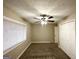 Bedroom featuring plush carpet, neutral walls, ceiling fan, closet, and bright window at 1761 Carter Cir, East Point, GA 30344