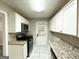 Modern kitchen with stainless steel appliances, granite countertops, white cabinets, and tile floors at 1761 Carter Cir, East Point, GA 30344
