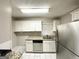Modern kitchen with stainless steel appliances, granite countertops, white cabinets, and tile floors at 1761 Carter Cir, East Point, GA 30344