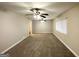 Spacious living room features neutral paint, plush carpeting, and modern ceiling fans at 1761 Carter Cir, East Point, GA 30344