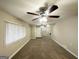 Open living room with neutral walls, carpet floors, ceiling fan, and ample natural light at 1761 Carter Cir, East Point, GA 30344