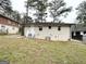 Exterior view of backyard featuring a white brick house with a small porch and mature trees at 2193 Polar Rock Sw Ave, Atlanta, GA 30315
