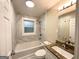 Updated bathroom showcasing marble tile, bathtub/shower combination, and granite vanity at 2193 Polar Rock Sw Ave, Atlanta, GA 30315