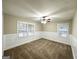 Cozy bedroom with neutral carpet, wainscoting, ceiling fan, and natural light from multiple windows at 2193 Polar Rock Sw Ave, Atlanta, GA 30315