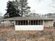 View of backyard and enclosed porch of single story brick home at 2537 Bonnybrook Sw Dr, Atlanta, GA 30311