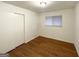 Bright bedroom featuring hardwood floors, window with blinds, and a closet at 2537 Bonnybrook Sw Dr, Atlanta, GA 30311