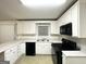 Updated kitchen featuring white cabinets, black appliances, and a stainless steel sink at 2537 Bonnybrook Sw Dr, Atlanta, GA 30311