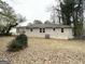 A spacious backyard featuring a well-maintained lawn and a classic brick house facade at 2544 Brentwood Rd, Decatur, GA 30032