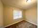 Simple bedroom with neutral walls, carpet, and natural light from the window at 2544 Brentwood Rd, Decatur, GA 30032