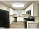 Well-equipped kitchen with granite countertops, stainless steel appliances, and white cabinets at 2544 Brentwood Rd, Decatur, GA 30032