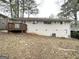 Large backyard featuring a wooden deck with a brick foundation, and mature trees at 2740 Bonnybrooke, Atlanta, GA 30311