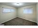 Cozy bedroom with plush carpeting, two windows for natural light, and neutral paint at 2740 Bonnybrooke, Atlanta, GA 30311