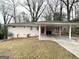 Single-story home with a covered carport and red front door at 2740 Bonnybrooke, Atlanta, GA 30311