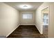 Neutral-toned room with new flooring, a window, and an open doorway at 2740 Bonnybrooke, Atlanta, GA 30311