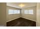 Bright bedroom featuring refinished hardwood floors, updated paint, and multiple windows at 2819 Gresham Rd, Atlanta, GA 30316