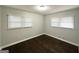 Bright bedroom with two windows, featuring refinished hardwood floors, and updated paint at 2819 Gresham Rd, Atlanta, GA 30316