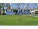 Charming one-story blue home featuring a well-maintained lawn, and a welcoming front porch at 2819 Gresham Rd, Atlanta, GA 30316