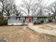 View of a charming one-story home with a red front door, complemented by a front yard at 2819 Gresham Rd, Atlanta, GA 30316