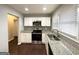 Close-up of newly updated kitchen featuring white cabinets, granite counters, and stainless steel appliances at 2819 Gresham Rd, Atlanta, GA 30316