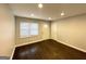Bright living room featuring newly refinished hardwood floors, a front door, and fresh paint at 2819 Gresham Rd, Atlanta, GA 30316