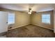 A bedroom with two windows, ceiling fan, neutral walls, and carpet flooring offers a calm atmosphere at 3976 Bright Star Rd, Douglasville, GA 30135